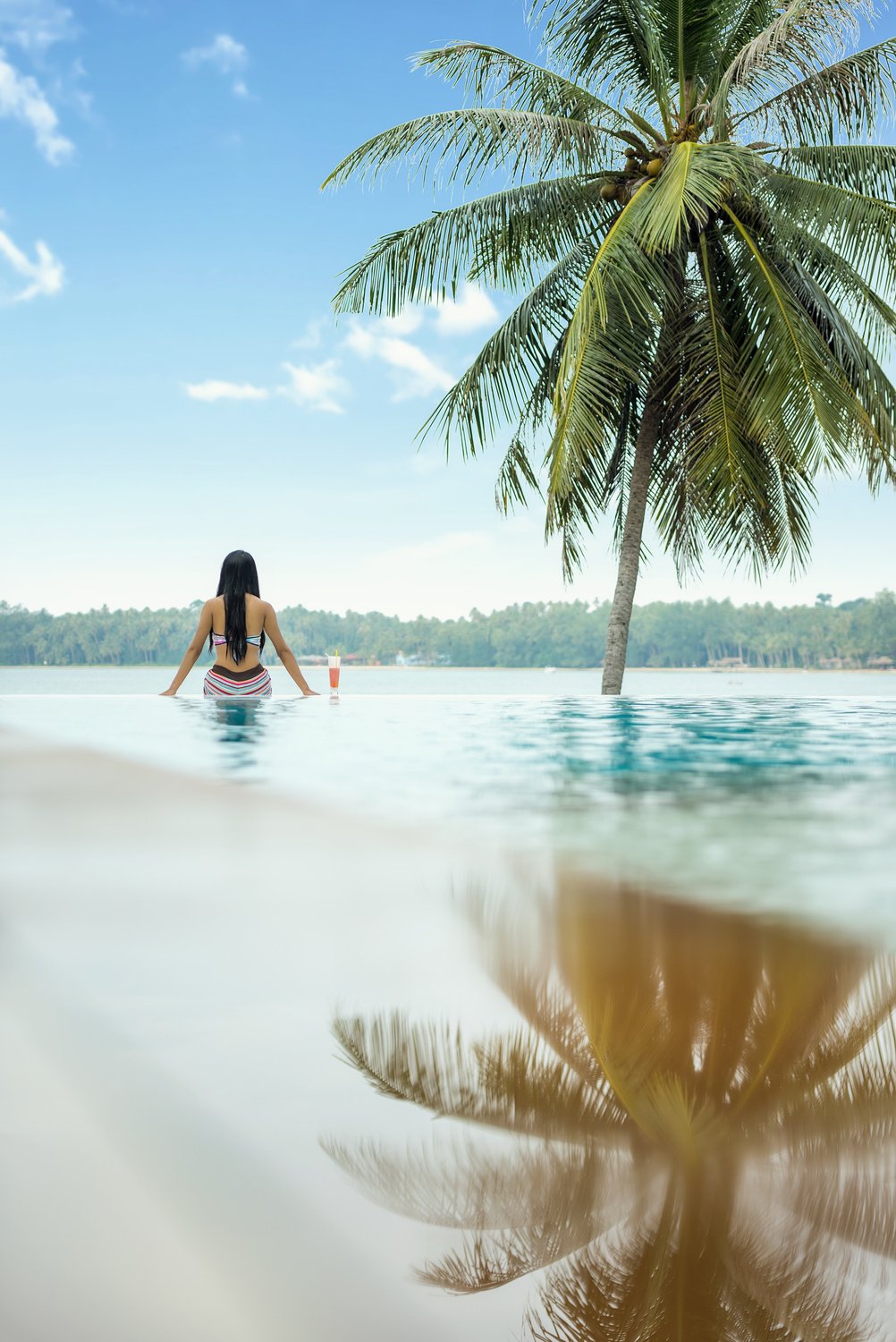 Girl Sitting on the Edge of the Pool